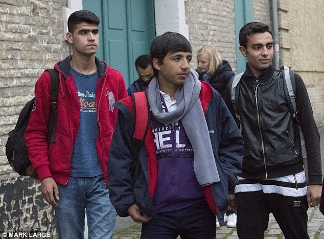 Three young migrants who arrived in Britain from France yesterday