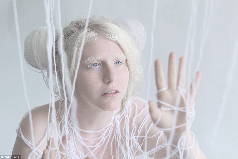 Model Ori gets tangled in white laces as part of the Yulia Taits